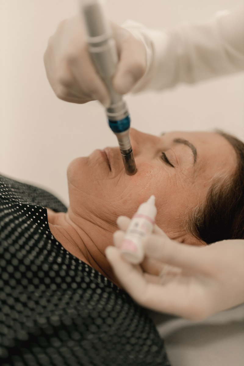 Woman receiving professional microneedling injection treatment from medical doctor
